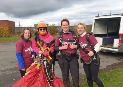 Skydivers with parachute after landing during a charity skydive fundraiser - Salisburys